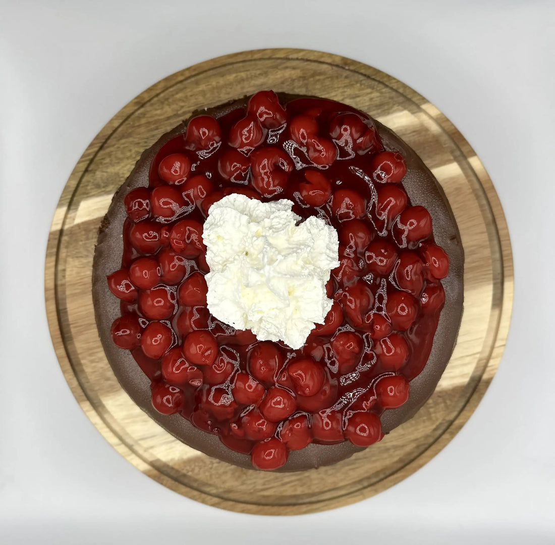 chocolate cheesecake with berry topping and whipped cream