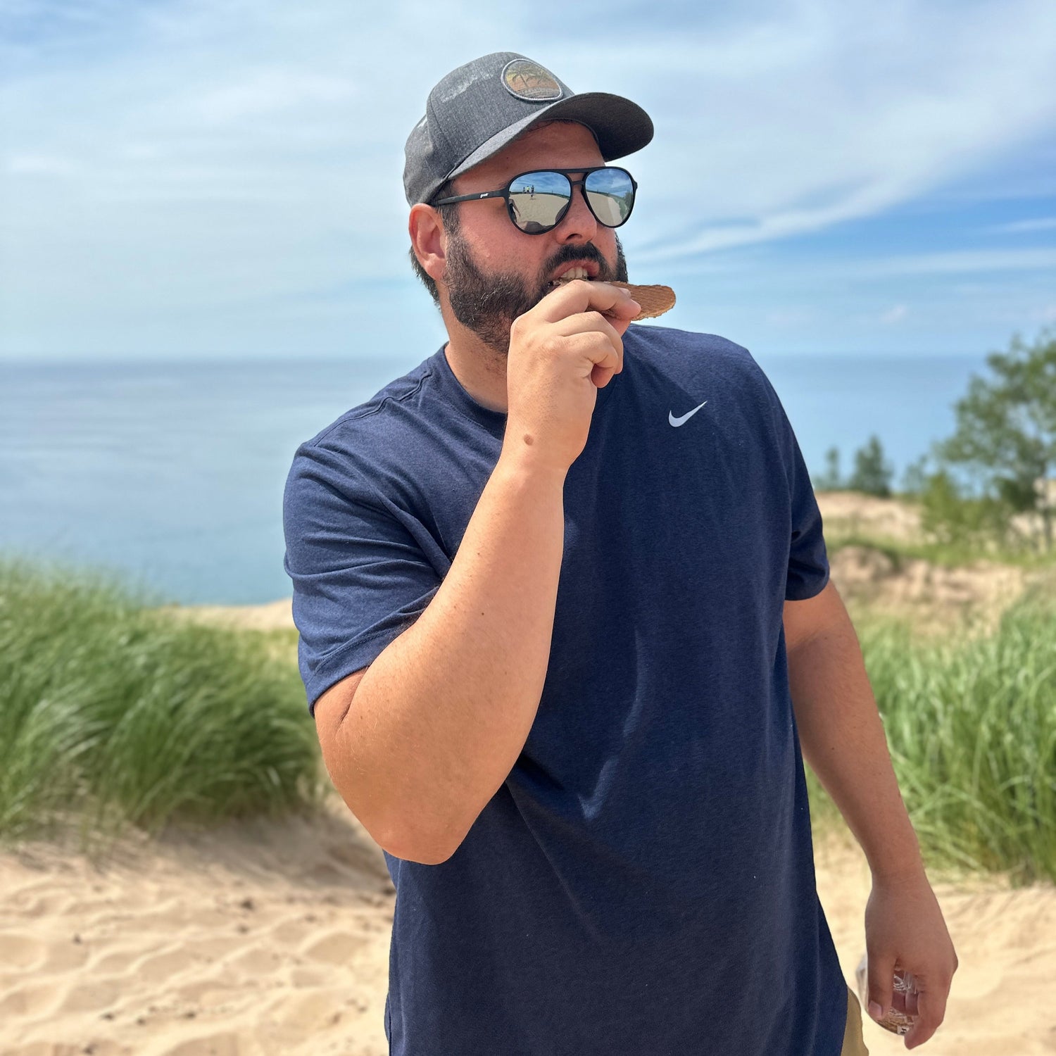 Man eating stroopwafel on beach 