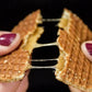 A Dutch stroopwafel being broken in half