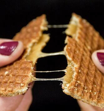 A Dutch stroopwafel being broken in half