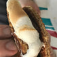 A roasted s'more squished between two stroopwafels