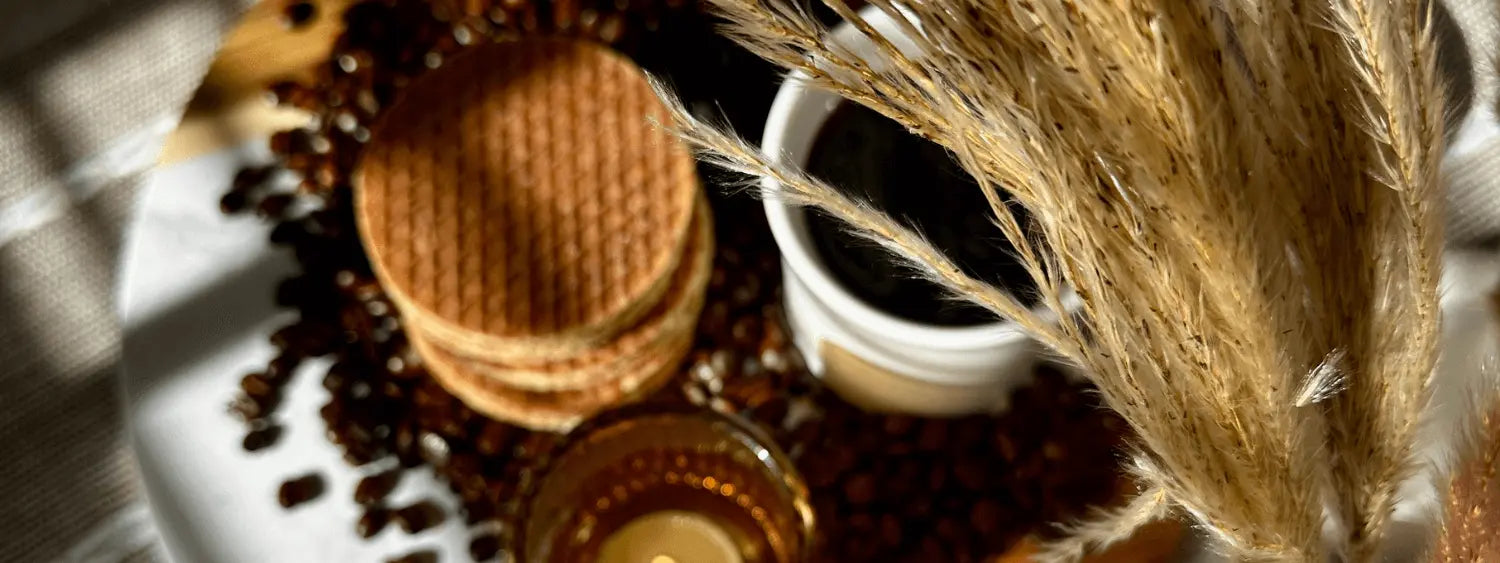 Stack of stroopwafels on serving platter with coffee and fall decor